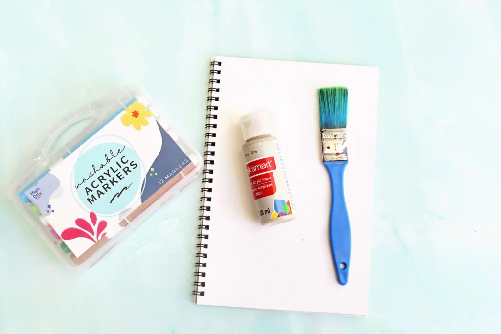 Letter E Elephant Handprint Craft - Cultivating Brilliant Minds supplies for this E is for Elephant Handprint craft: paper, paint brush, gray paint, and a black marker
