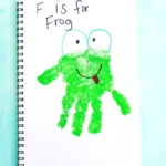 Notebook page with a green frog drawing and the words 'F is for Frog'.