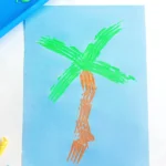 a Fork Painted Palm Tree on blue paper