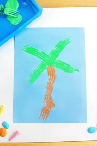 a Fork Painted Palm Tree on blue paper