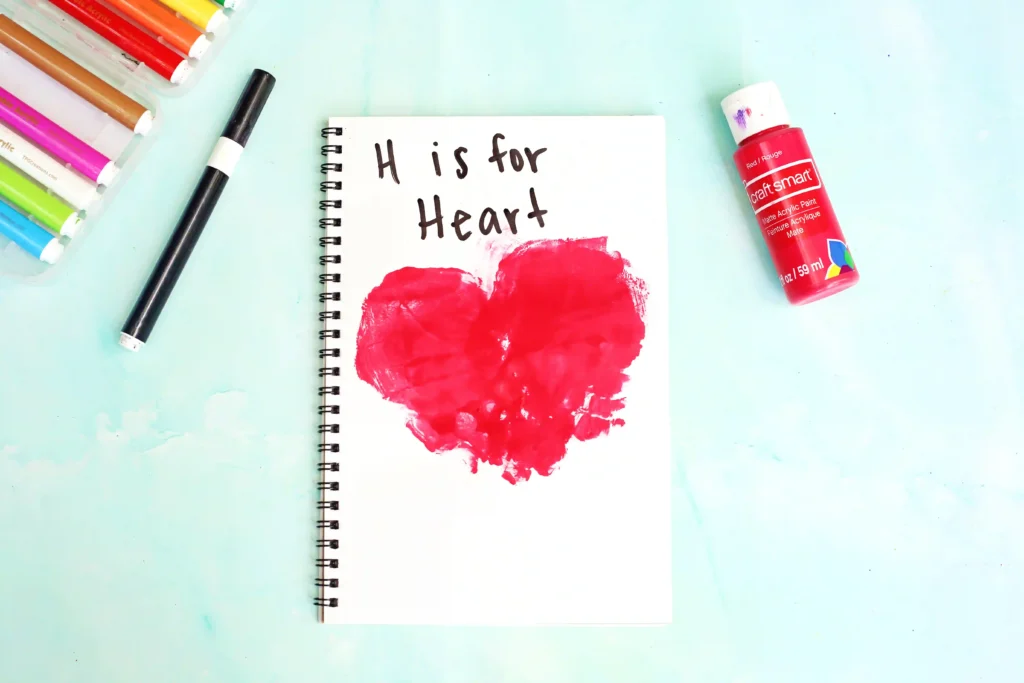 a Letter H Handprint Craft that uses two red handprints to make a heart