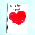 a Letter H Handprint Craft that uses two red handprints to make a heart