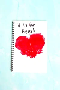 a Letter H Handprint Craft that uses two red handprints to make a heart