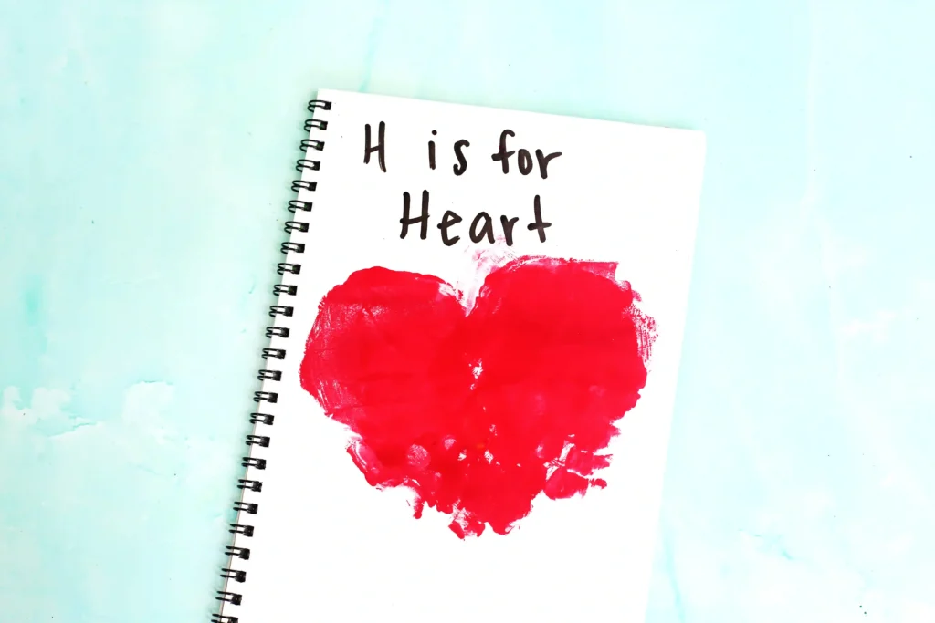 a Letter H Handprint Craft that uses two red handprints to make a heart