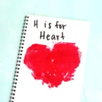 a Letter H Handprint Craft that uses two red handprints to make a heart