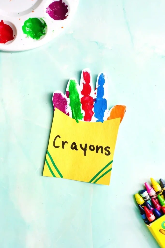 a Crayon Box Handprint Craft that uses the handprint as crayons inside a construction paper crayon box