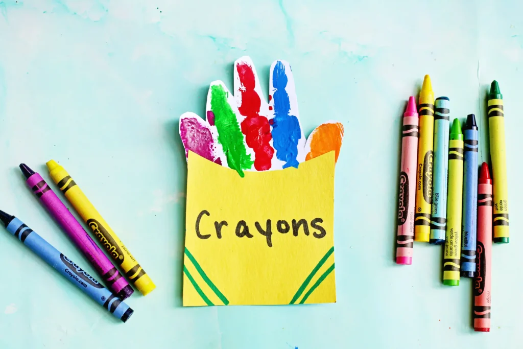 a Crayon Box Handprint Craft that uses the handprint as crayons inside a construction paper crayon box