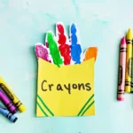 a Crayon Box Handprint Craft that uses the handprint as crayons inside a construction paper crayon box
