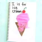 a letter I handprint craft that is an ice cream cone with a pink ice cream handprint, a cherry, and the words :I is for ice cream"