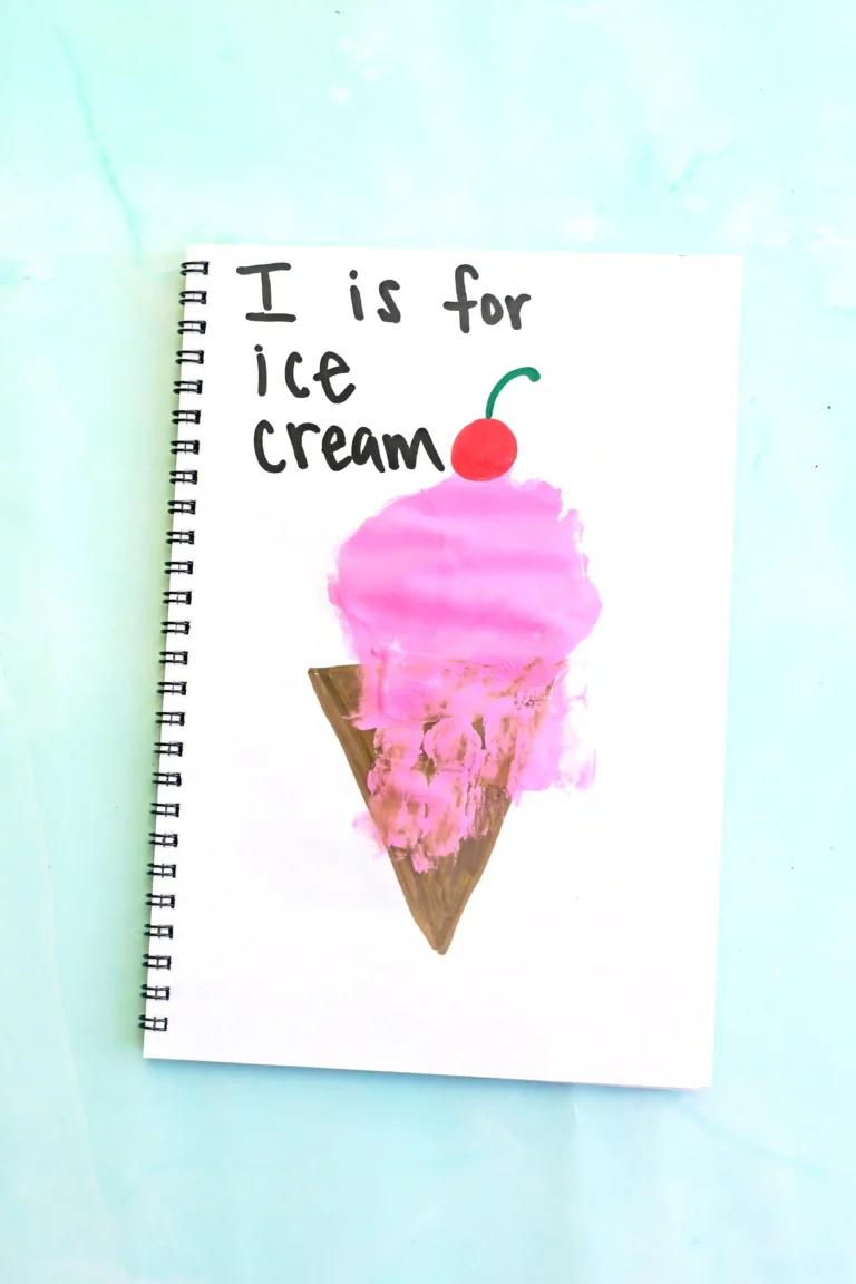 a letter I handprint craft that is an ice cream cone with a pink ice cream handprint, a cherry, and the words :I is for ice cream"