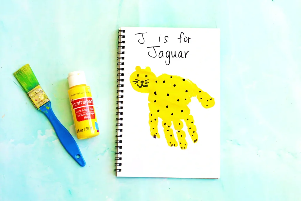 a letter J handprint craft that is decorated to look like a jaguar