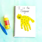a letter J handprint craft that is decorated to look like a jaguar