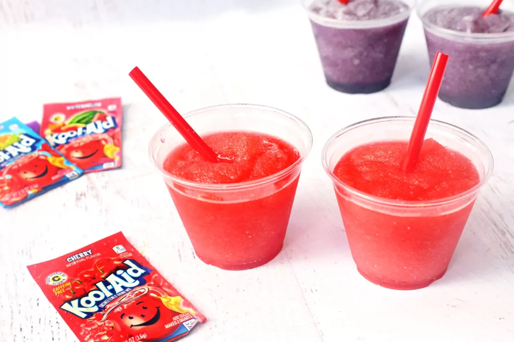 Kool-Aid Slushie - Cultivating Brilliant Minds a Kool-Aid Slushie in a clear cup with a red straw
