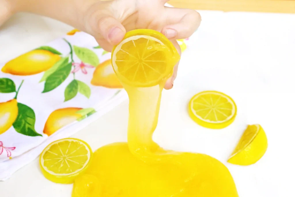 Lemon Slime - Cultivating Brilliant Minds lemon slime with a kid pulling a plastic lemon out of it
