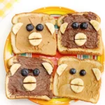 Monkey Face Toast made out of bread, peanut butter and chocolate hazelnut spread, bananas, and blueberries