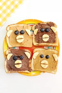 Monkey Face Toast made out of bread, peanut butter and chocolate hazelnut spread, bananas, and blueberries