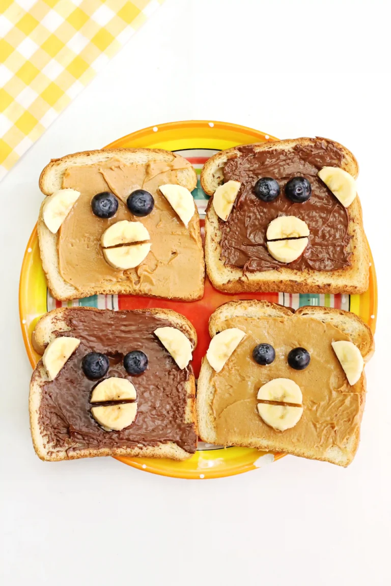 Monkey Face Toast made out of bread, peanut butter and chocolate hazelnut spread, bananas, and blueberries
