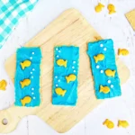 Ocean Graham Crackers that are graham crackers with blue frosting, goldfish crackers, and csprinkles