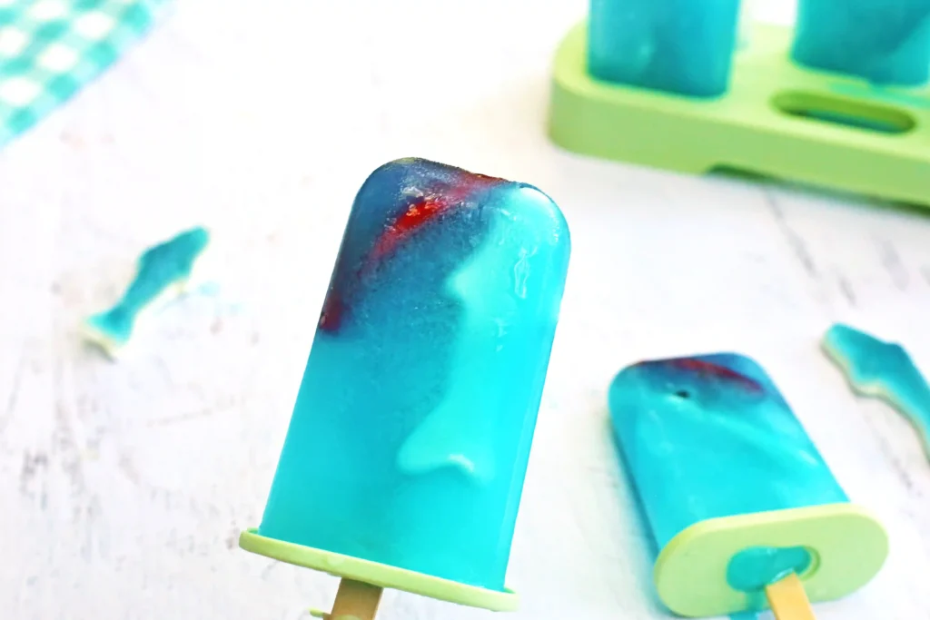 ocean popsicles made out of lemonade with gummy sharks inside