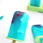 ocean popsicles made out of lemonade with gummy sharks inside