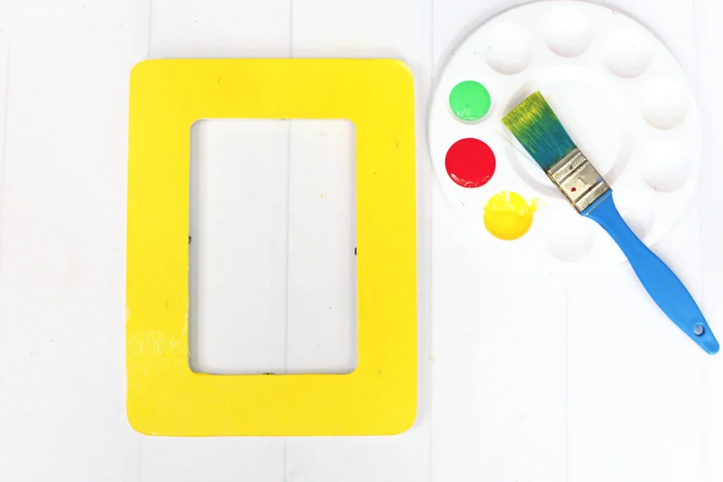 a wooden photo frame painted yellow for this first day of school craft