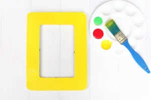 a wooden photo frame painted yellow for this first day of school craft