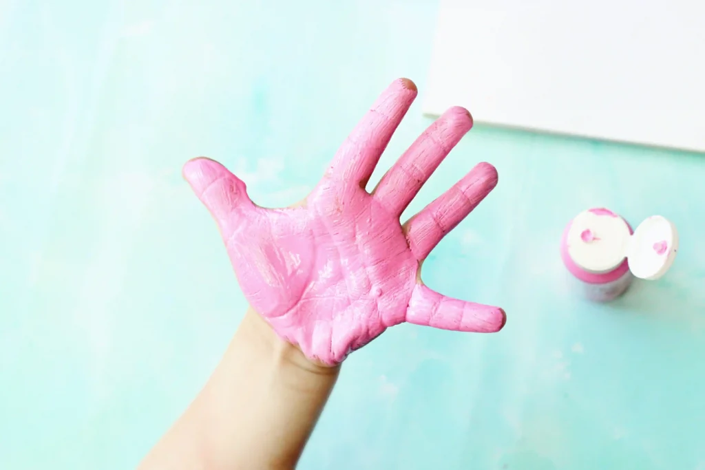 a child's hand painted pink for this handprint art ice cream craft