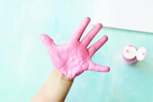 a child's hand painted pink for this handprint art ice cream craft
