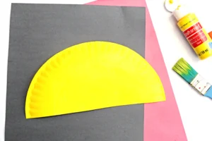 a paper plate cut in half and painted yellow for this back to school craft