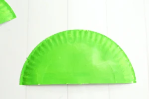 a paper plate cut in half and painted green