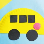 a paper plate school bus craft that is a paper plate cut in half, and painted yellow with construction paper windows, stop sign, and wheels