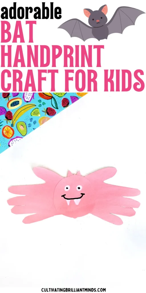 a pink bat handprint craft made out of pink construction paper with a drawn on face