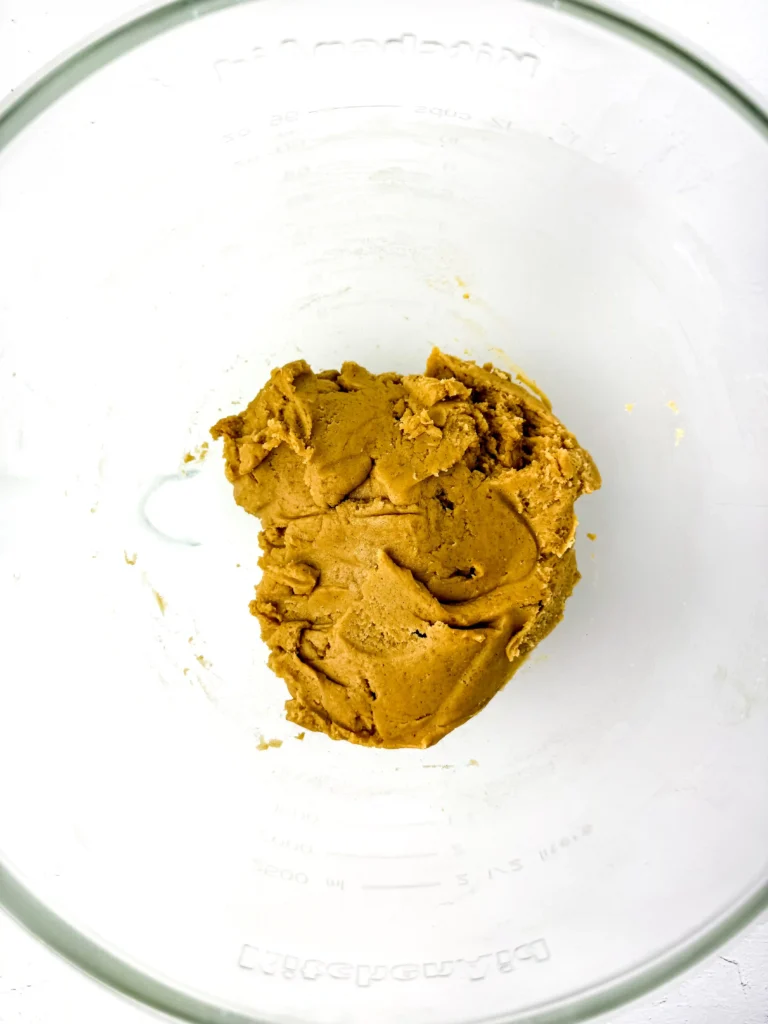 pumpkin cookie dough on a white surface for this pumpkin dessert