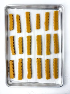 pumpkin spice crinkle fries on parchment paper on a baking sheet
