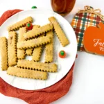 Pumpkin Spice Cookie Fries on a white plate with mini pumpkins next to a plaid hot pad