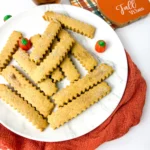 Pumpkin Spice Cookie Fries on a white plate with mini pumpkins next to a plaid hot pad