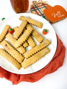 Pumpkin Spice Cookie Fries on a white plate with mini pumpkins next to a plaid hot pad