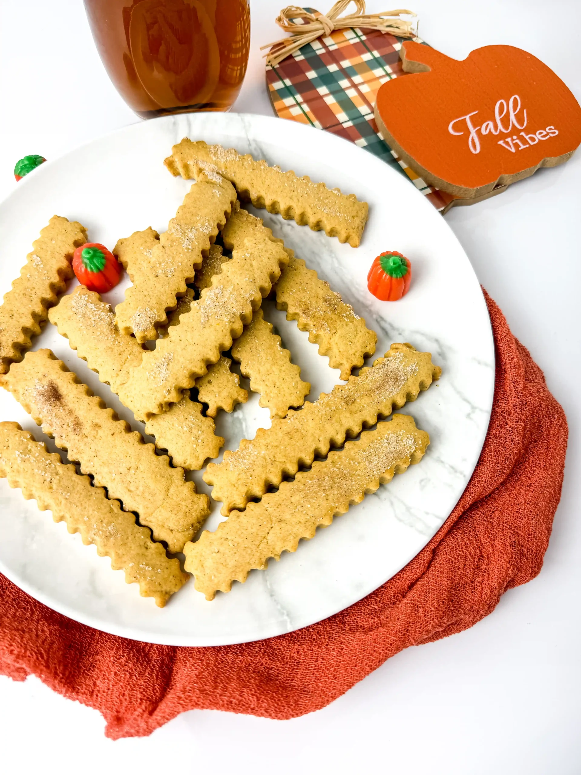 Pumpkin Spice Cookie Fries on a white plate with mini pumpkins next to a plaid hot pad