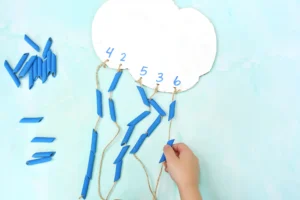 a Raindrop Counting Activity that is a cardboard cloud with blue dyed pasta strung on