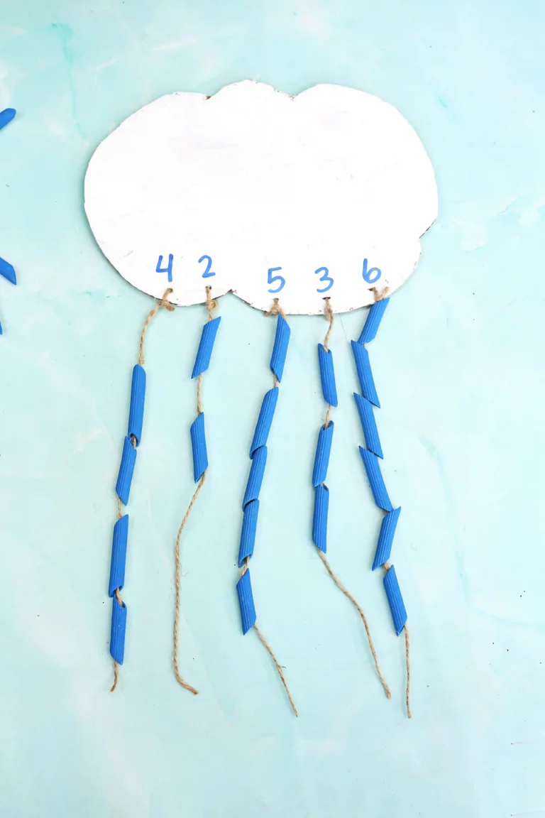 a Raindrop Counting Activity that is a cardboard cloud with blue dyed pasta strung on