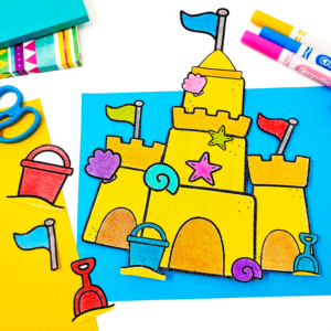 a sandcastle craft on blue paper with markers, scissors, and notebooks in the background