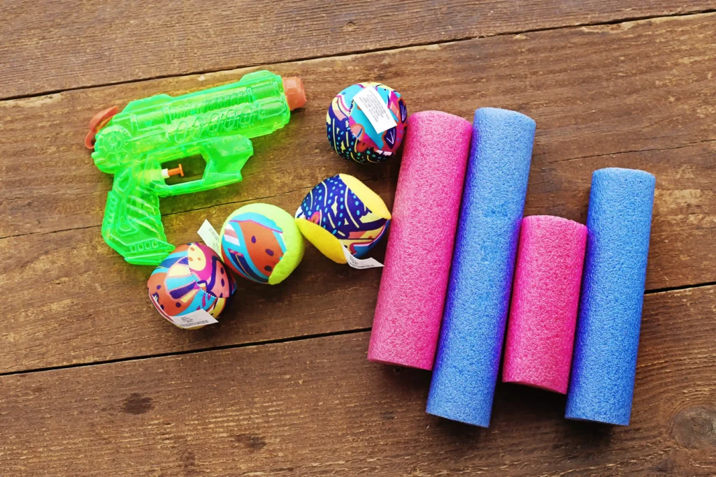 Outdoor Water Play Activity - Cultivating Brilliant Minds supplies for the Outdoor Water Play Activity - squirt gun, balls, and pool noodles