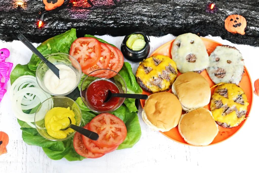 a spooky burger bar with cheeseburgers that have ghost faces cut out of the cheese