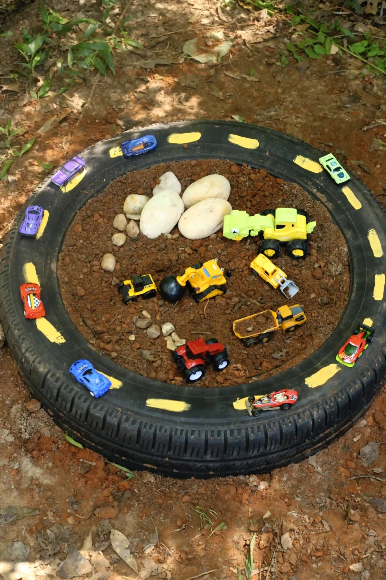 a tire raceway car race track for kids that uses an old tire with toy cars