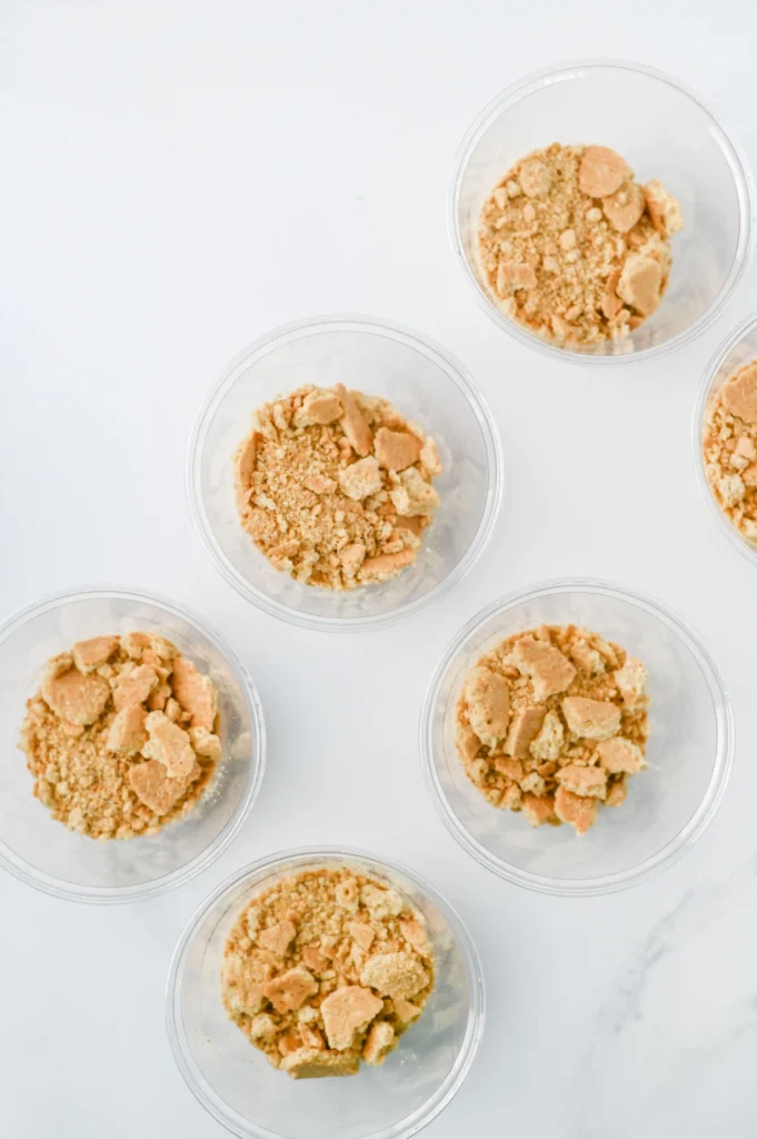Apple Pie In A Cup - Cultivating Brilliant Minds clear cups with crushed graham crackers for this fall snack for kids