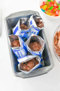 a kids party dessert of bags of mini oreos with chocolate pudding to make dirt cups