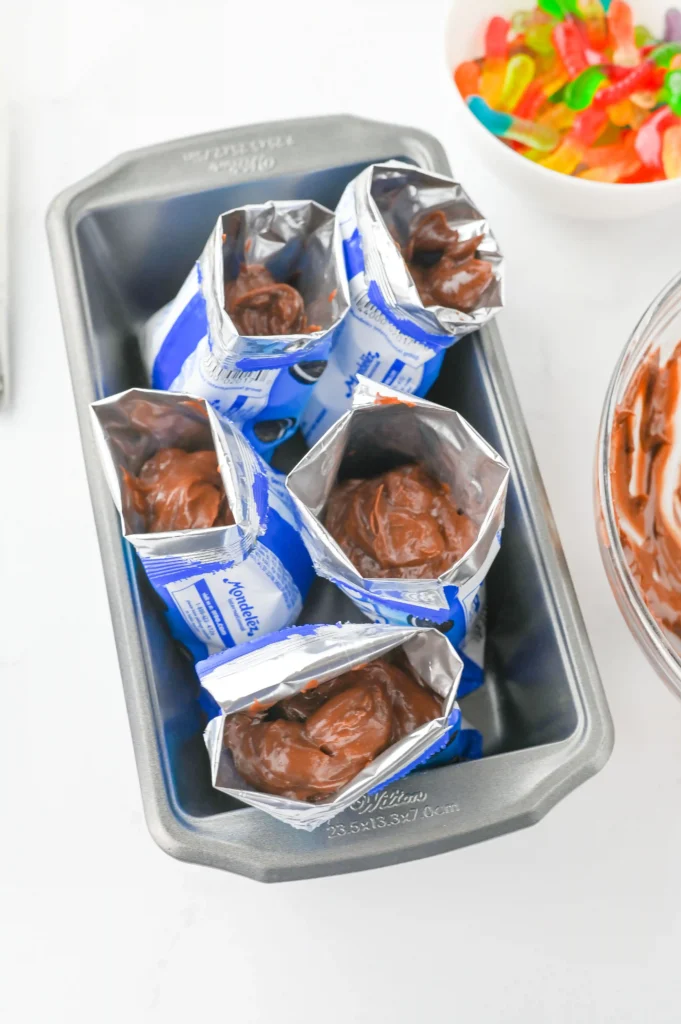 a kids party dessert of bags of mini oreos with chocolate pudding to make dirt cups