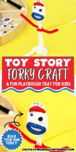 Close-up of a hand holding a DIY toy story forky made from a plastic spoon, with a blue mouth, red eyebrows, and red pipe cleaner arms on a yellow surface.