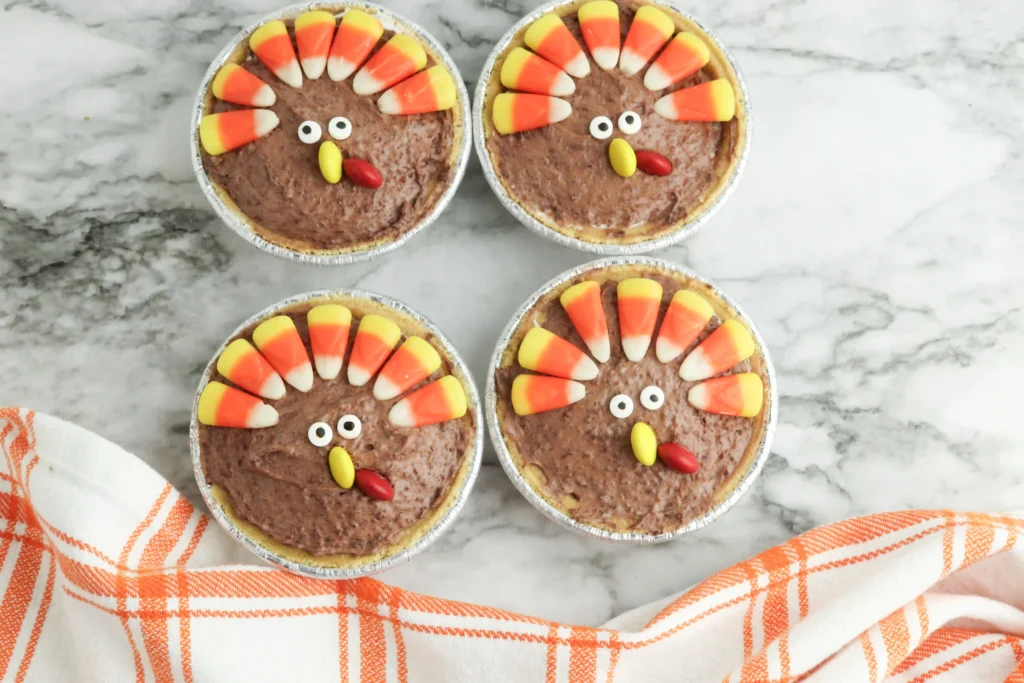 mini turkey pies made with chocolate pudding and decorated to look like turkeys