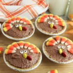 mini turkey pies made with chocolate pudding and decorated to look like turkeys